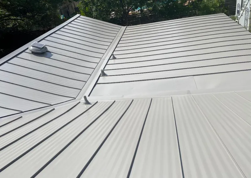 Solar attic fan installed on a metal roof for Roof Ventilation in Burien